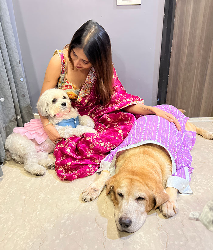 Krishna with her dogs dressed up
